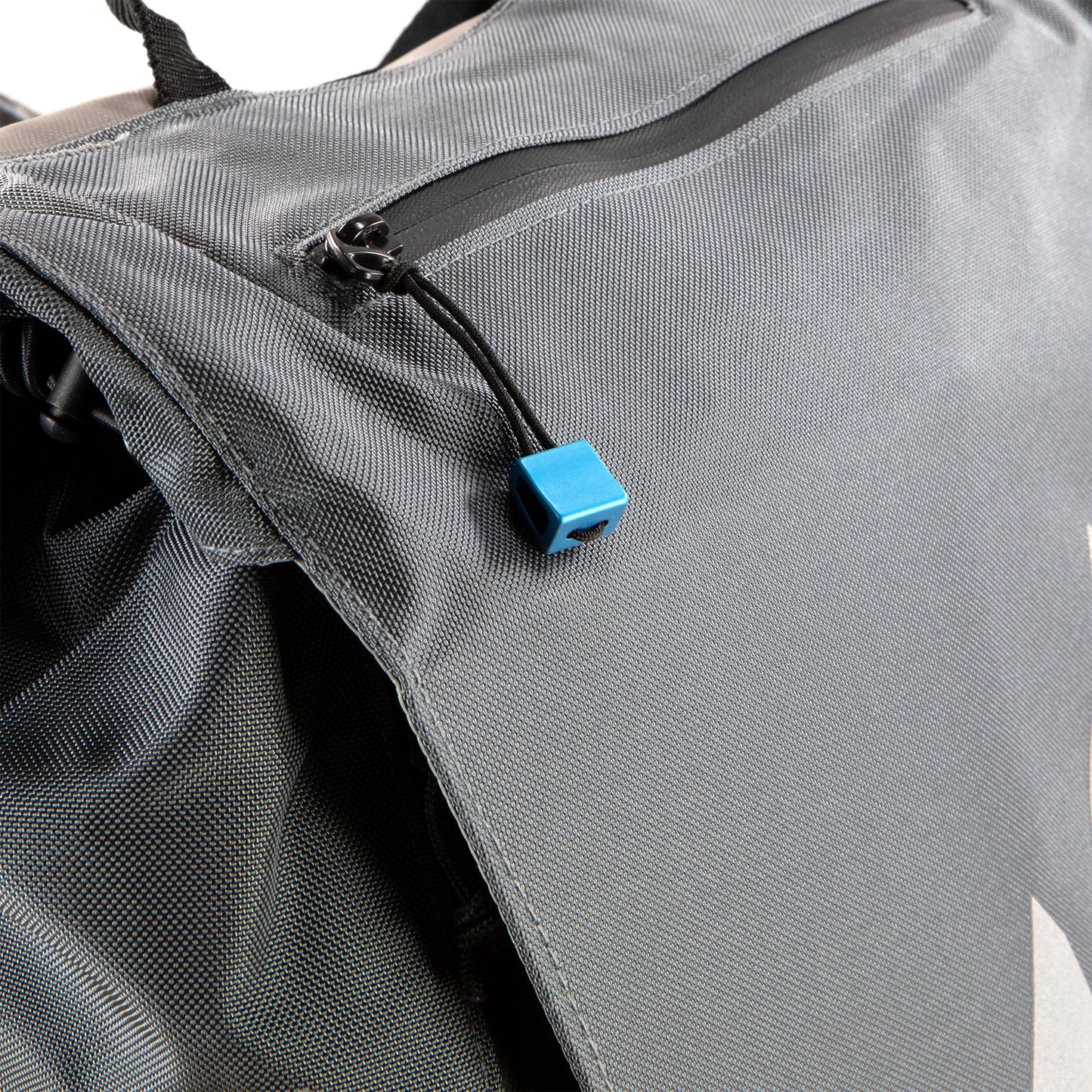 Close up view of sunglass pouch zipper on City Sender Backpack